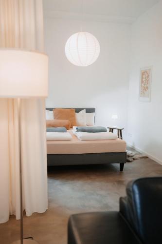a bedroom with a bed and a pendant light at Historische, moderne Stadtwohnung in Riedlingen