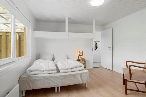 a bedroom with white walls and a bed with white pillows at SB134-Sydals-Osterbyvej-54-B in Østerby