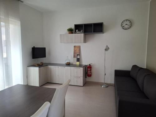 a living room with a couch and a table at Eira Apartment Potenza in Potenza