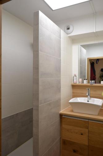 a bathroom with a sink and a mirror at Appartement Orelle spa et piscine in Orelle