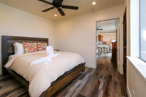 a bedroom with a bed and a ceiling fan at Sea Gull Queen Suite in Cayucos