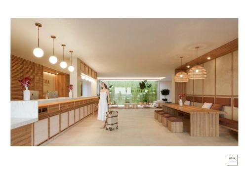 a woman is standing in the kitchen of a house at Aduana Suites in Salou