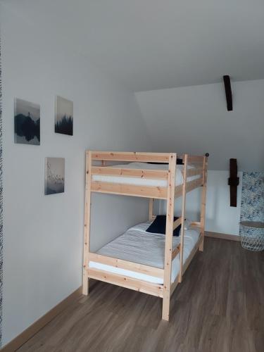 a set of bunk beds in a room at Gites de la Janais in Le Pin