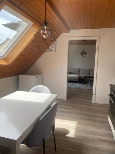 a dining room and living room with a skylight at Apartment Kuhl in Selb