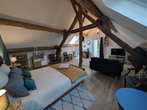 a bedroom with a bed and a living room at Le Clos Macé - Maison d'hôtes proche BLOIS CHAMBORD in Saint-Denis-sur-Loire