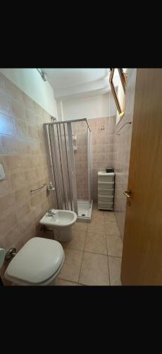 a bathroom with a shower and a toilet and a sink at Casa Vacanze Oasi Felicita in Nova Siri Marina