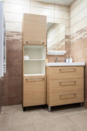 a bathroom with a sink and a mirror at Appart Cosy I Centre-ville in Istres