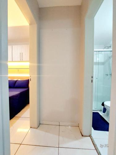 a bathroom with a glass door leading to a bedroom at Graciosa Reserva Ipanema in Porto Alegre