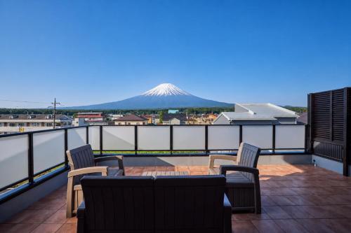 a balcony with a view of a snow covered mountain at Miire Mt Fuji Forest in Fujikawaguchiko