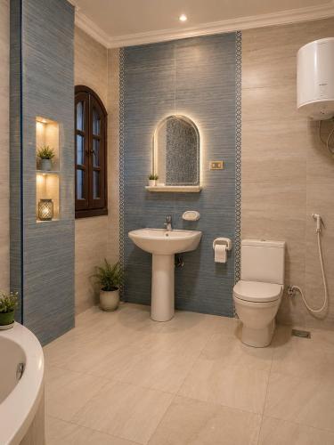 a bathroom with a toilet and a sink at Sol Pyramids Rooftop View Giza in Cairo