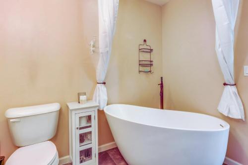 a bathroom with a white tub and a toilet at The Nook in Coeur d'Alene