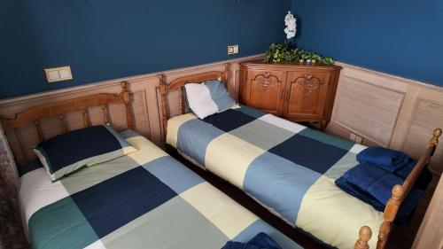 two beds sitting next to each other in a room at Annsmuiža in Salacgrīva