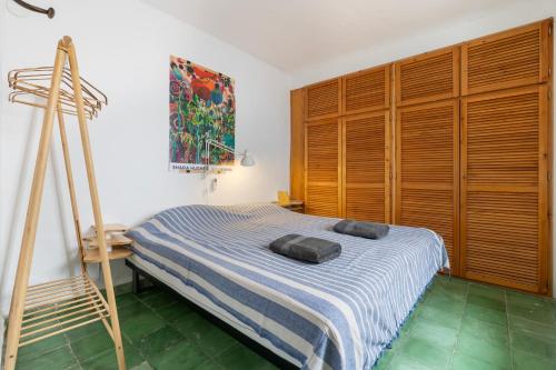 a bedroom with a bed with two pillows on it at Casa Terraza in La Herradura