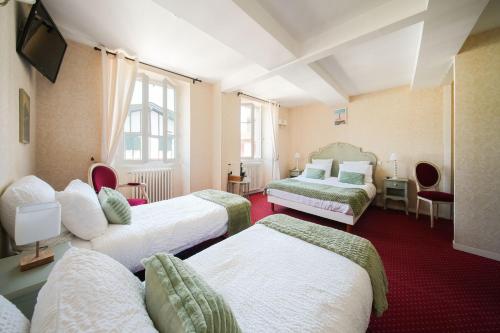 a hotel room with three beds and a television at Logis Hôtel Auberge Lukaïna in Urrugne