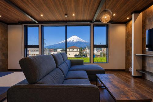 a living room with a couch and a mountain view at Miire Mt Fuji Traditional in Fujikawaguchiko
