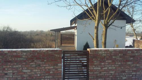 a brick wall and a building with a tree at Widokówka in Tarnobrzeg