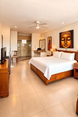 a bedroom with a large bed and a television at Nuevo Amanecer in Tepoztlán