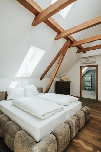 a bedroom with a large bed and a couch at ILLYRHof in Gamlitz