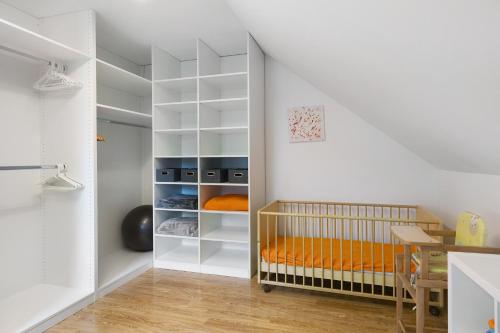 a nursery with a crib in a white room at Fewo Krick in Bad Soden-Salmünster