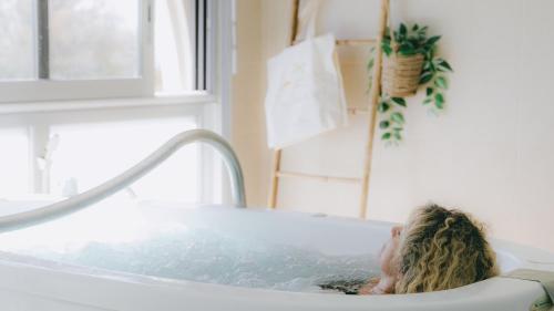 a woman sitting in a bath tub at Hôtel Les Corallines - Thalasso & Resort in La Grande Motte