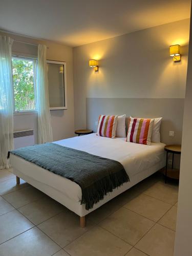 a bedroom with a large white bed with two pillows at CASA Petra Rosa in Peri