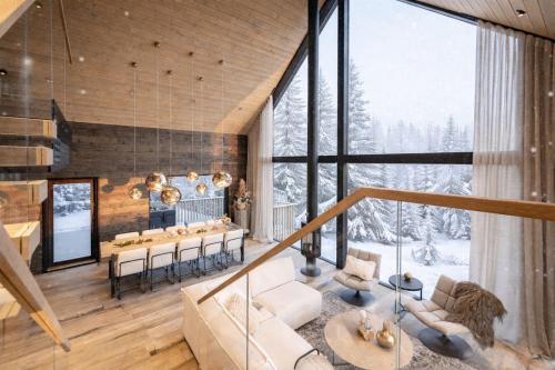 a large living room with a table and chairs at AURA Arctic Chalets - Grand Panoramic & Grand Hideaway in Saariselka