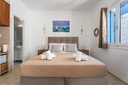 a bedroom with a large bed with white pillows at Tzivaeriparos studio in Piso Livadi