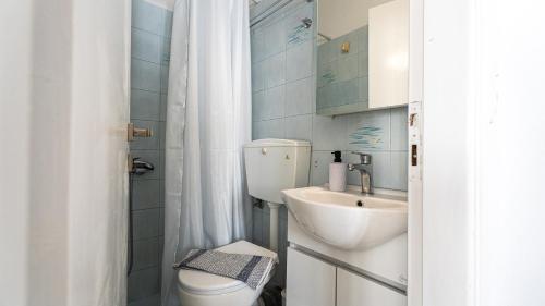 a small bathroom with a toilet and a sink at Tzivaeriparos studio in Piso Livadi