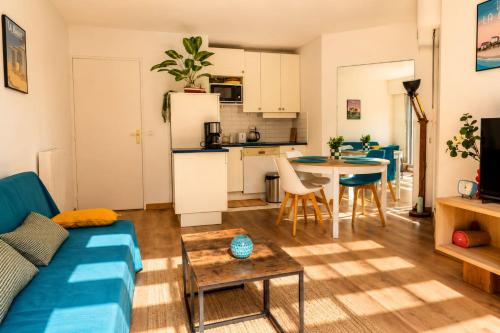 a living room with a couch and a table at Pool 3 Balconies & Parking in La Baule