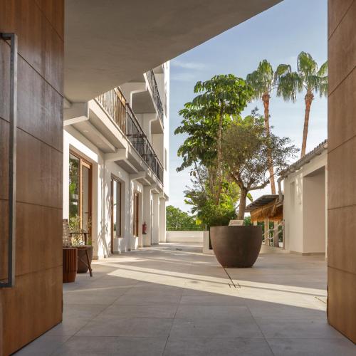 an empty hallway of a building with palm trees at Boutique Apartments Marsol Ibiza in Santa Eularia des Riu