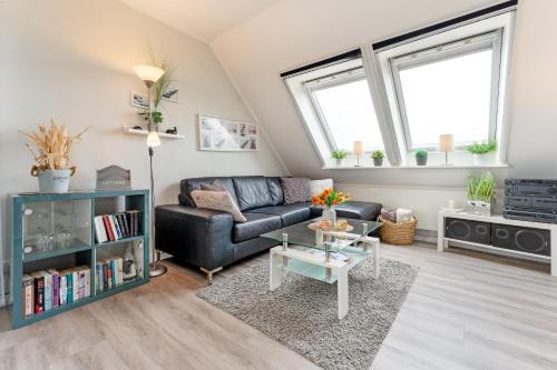 a living room with a couch and a table at Inselglück in Fehmarn