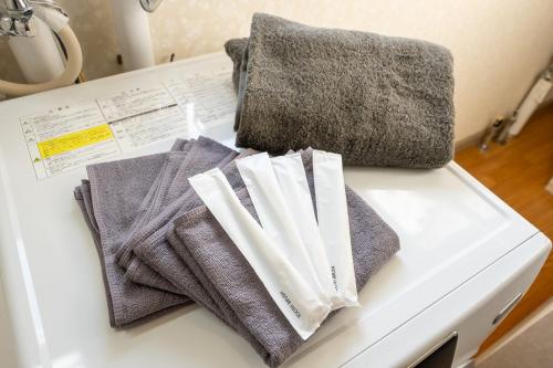 a pile of towels sitting on top of a table at Seaside Deer Shiraoi in Shiraoi