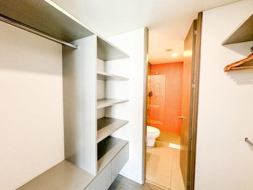 a small bathroom with a toilet and a shower at Distrito prime 1-303 in Bogotá