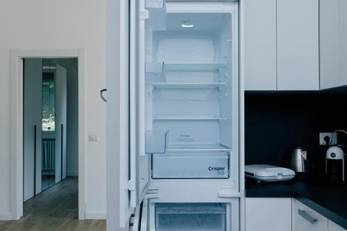 an empty refrigerator with its door open in a kitchen at Villa SOL Lago di Endine in Ranzanico