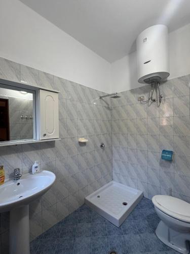 a bathroom with a toilet and a sink at Pararse Apartments in Vlorë