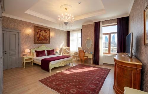 a bedroom with a bed and a television and a desk at West inn Luxury Baku in Baku