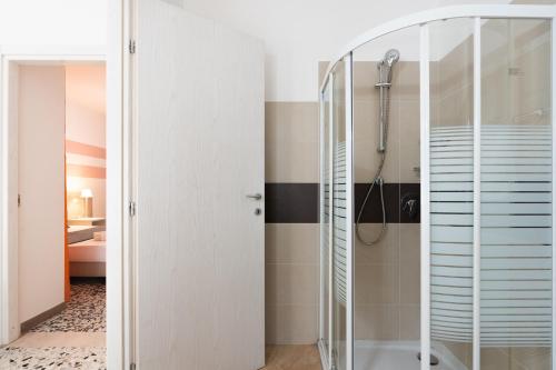 a bathroom with a shower with a glass door at B&B K Beach Lake Endine in Endine Gaiano