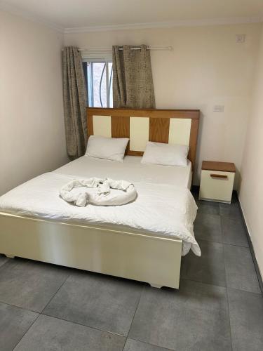 a bedroom with a bed with a robe on it at carmel cabins suite nu 8 in Haifa