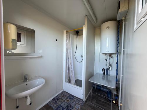 a small bathroom with a sink and a shower at Camping Dorfer in Spielberg