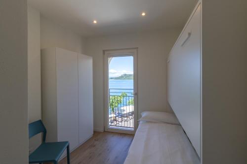 a bedroom with a bed and a view of the ocean at Casa Bortolo in Garda