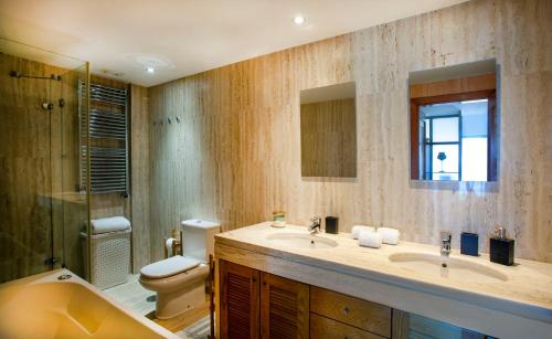 a bathroom with a sink and a toilet and a shower at Sea view Luxury Apartment in Paço de Arcos