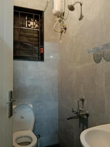 a bathroom with a toilet and a sink at Coastal villa in Tirupporūr