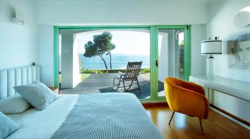 a bedroom with a bed and a view of the ocean at Sea view Luxury Apartment in Paço de Arcos