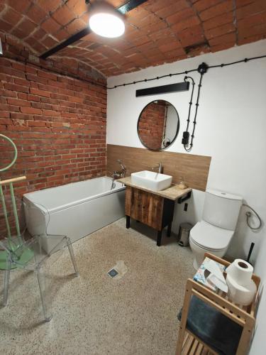 a bathroom with a tub and a sink and a toilet at Studio Lawendowe Ranczo in Zawichost
