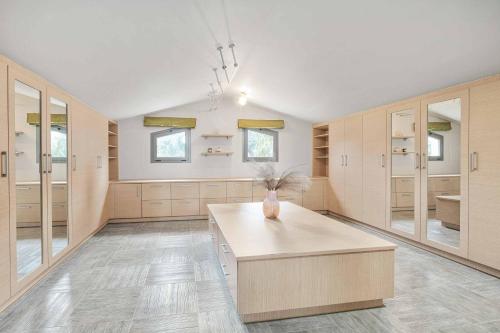 a large kitchen with a vase on a table at Villa Elegio in Kavos