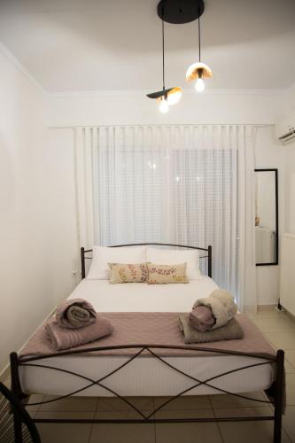 a bedroom with a bed with towels on it at Iasonas Apartment 2 in Nafplio