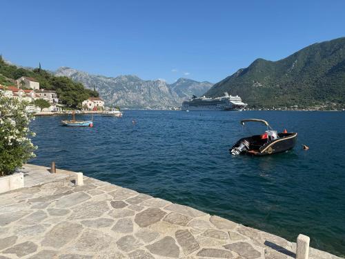 a small boat in a large body of water at Apartment Forteca Lux in Perast