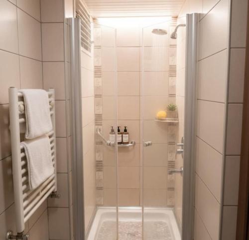a shower with a glass door in a bathroom at Çelik Crown Hotel in Trabzon