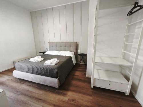 a bedroom with a bed and a book shelf at Faber Home in Conversano