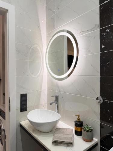 a bathroom with a white sink and a mirror at ILoveHome Mini in Kalamata